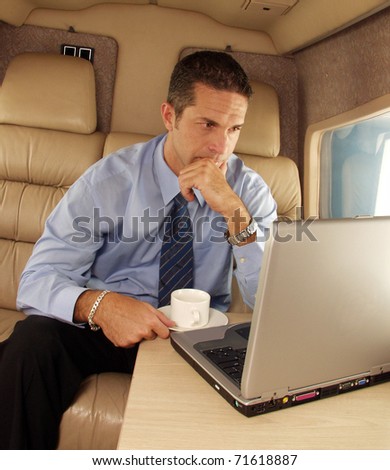 Business man working at private jet.