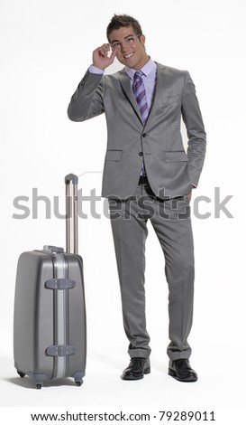 Young businessman holding a luggage on white background. Young traveler businessman on white background.