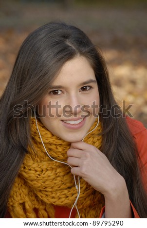 Autumn young hispanic woman portrait listening music.
