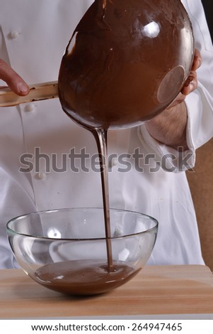 Pouring melted dark chocolate,cooking with melted dark chocolate, chocolate cream bowl.