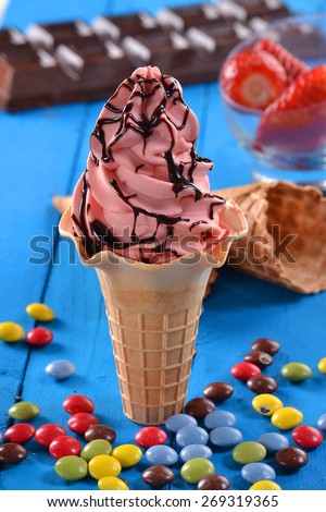 Strawberry ice cream cup and chocolate syrup on party ambient. Strawberry sundae icecream and ingredients.