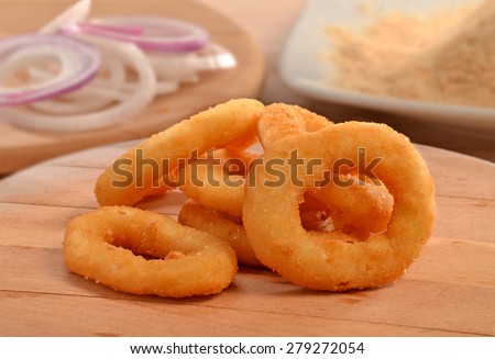 Onion rings on wood table and ingredients