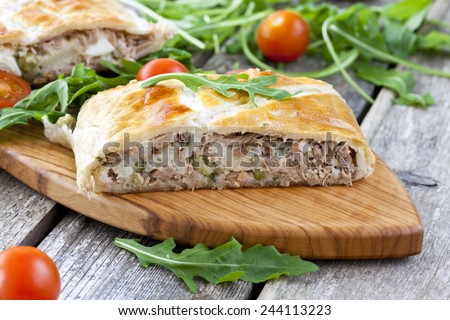 pie of puff pastry with tuna, rice, egg and peas