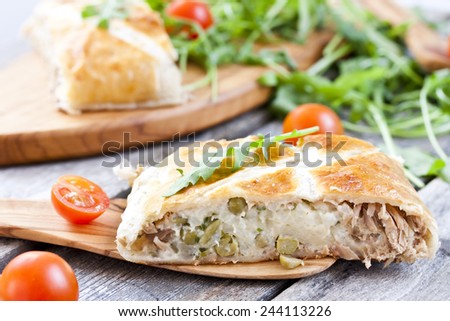 pie of puff pastry with tuna, rice, egg and peas