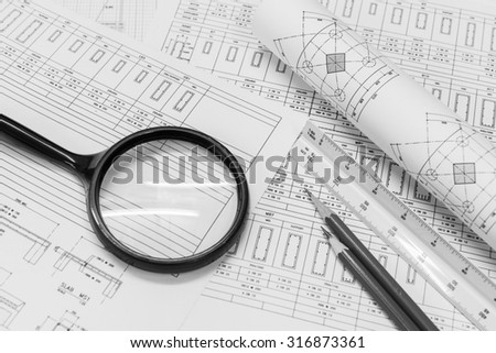 Construction design work.construction drawing paper with the triangular scale ruler and pencil. black and white color.