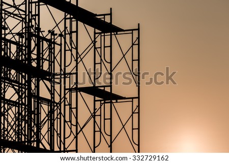 Silhouette of scaffolding in the construction site before to night time or sunset time. worker empty.
