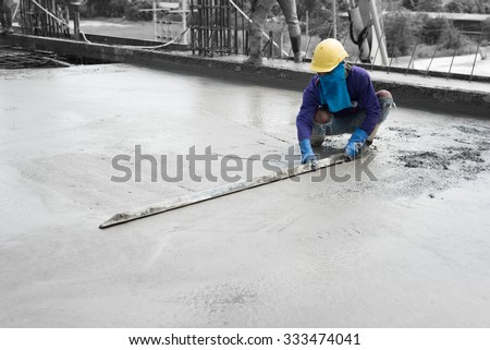 plasterer concrete cement work. using a trowel to smooth or leveling concrete slab floor work step of the building construction.