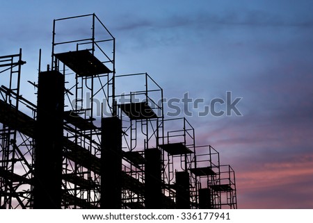 Silhouette of scaffolding in the construction site before to night time or sunset time. worker empty.