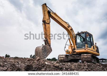 Excavators machine in construction site on sky background