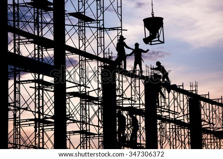 Silhouette of worker. Construction Building casting concrete work on scaffolding.