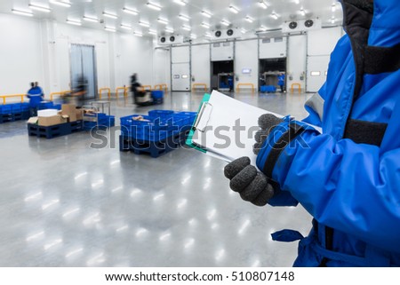 Hand of worker with clipboard checking ready meals goods in the warehouse., Import and export management system for customer service concept.