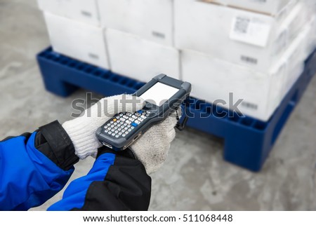 Bluetooth barcode scanner checking goods in the cold room or warehouse