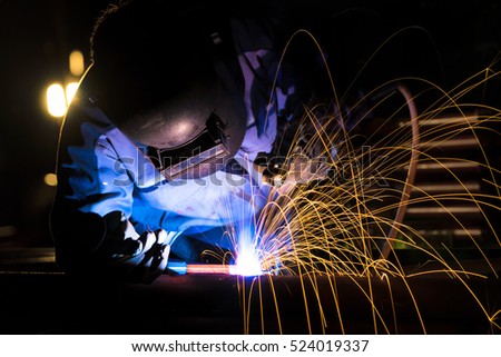 Welder at the industrial factory welding or steel fabrication preparation for steel structure on construction work