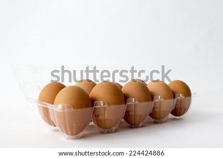 Ten brown chicken eggs in plastic container package; chicken eggs are high protein and suitable for all ages. People who eat will healthy and strong.