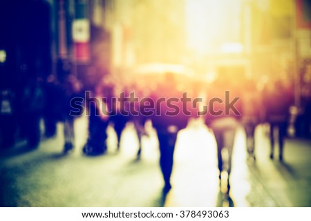people walking in the street, blurry