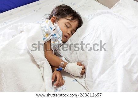 Children sick sleeping on the bed at the hospital