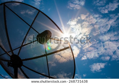 Satellite dishes communication technology network with sun and white cloud in background