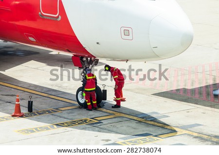 Airplane in airport serviced by the ground crew before departure at Don Mueang international Airport THailand