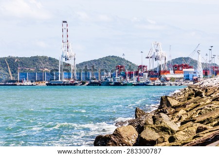rock dam protection sea and blurred background of trade port
