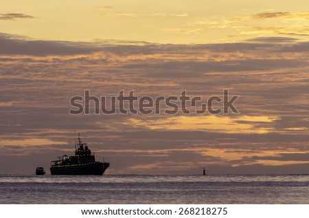 Sunset, Big boat and small boat in the sea