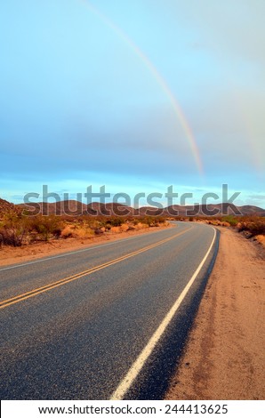 Highway to heaven? A road right after a storm leading right to a rainbow.