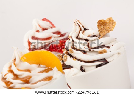 Set of yogurt ice cream with fresh fruits, toppings, marmalade, chocolate and caramel