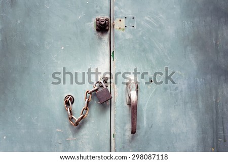 Grunge padlock chained and locked on telephone exchange cabinet
