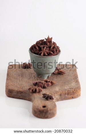 star of anise , asian herbs are on wooden plate.