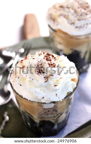 banoffee oreo pie in a cup, spilled with caramel and whipped cream, delicious dessert.