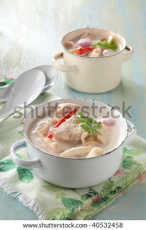 tom kha gai or coconut milk soup with chicken breast. The populat Thai menu, ready to serve in a white pot.