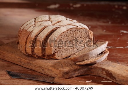 whole wheat bread pieces are on the wooden plate.