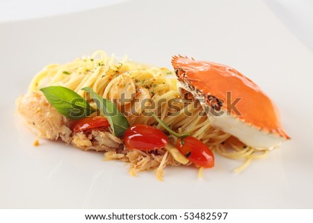 Spaghetti with crab. Italian food, serve in a white plate.