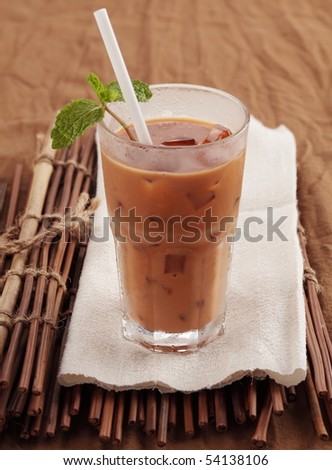 Iced milk tea on brown cloth background.