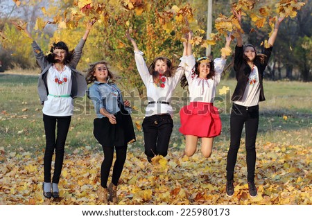 Girl throw autumn leaves into the air