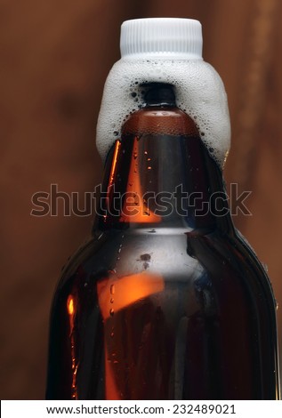 plastic  Bottle of beer with vials, foam and a plastic cover