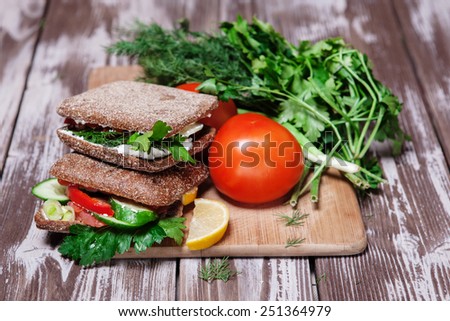 deli sandwich with salmon on the old wooden table