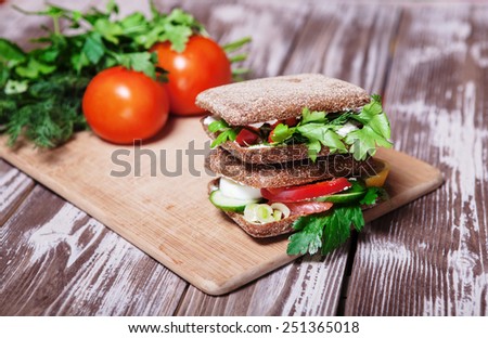 deli sandwich with salmon on the old wooden table