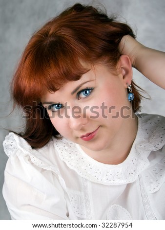 Young blue eyed woman with blue earring
