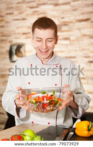 Bright portrait of man cooking salad