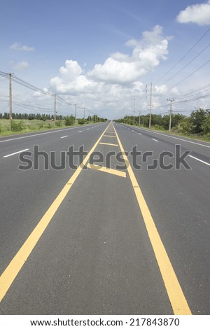 Cloud on road with  the yellow line share lane side the electric poles
