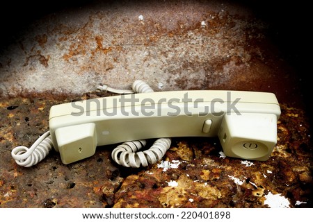 old broken telephone on sandstone background