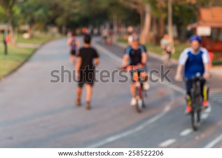 Blurring of the park in the morning,some ran and some cyclists.