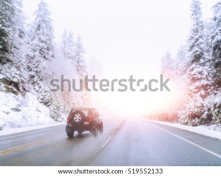 scenic veiw of empty road with snow covered landscape while snowing in winter season.