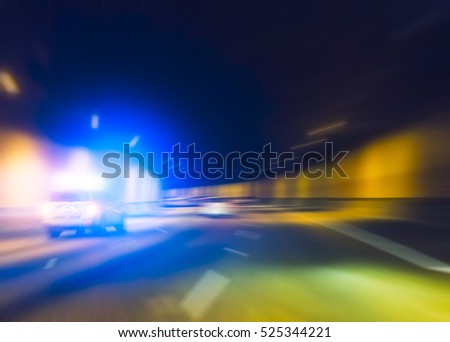 police car with lighting while  running in tunnel. -blurred.
