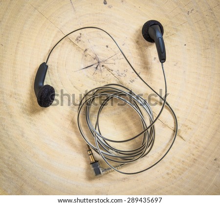 earphones on wooden background