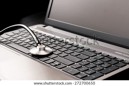 Stethoscope resting on a computer keyboard - concept for online medicine or IT support