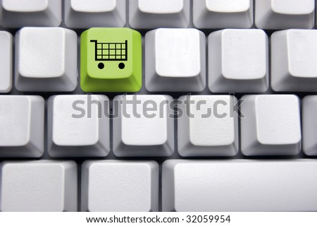 shopping cart in green on blank keyboard