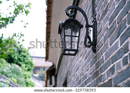 European style lantern on a brick wall of Chinese house