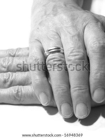 stock photo Female old hand with two wedding rings on the finger