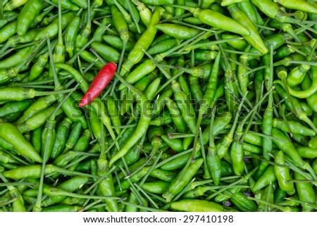 Red chili on green chili backgrounds